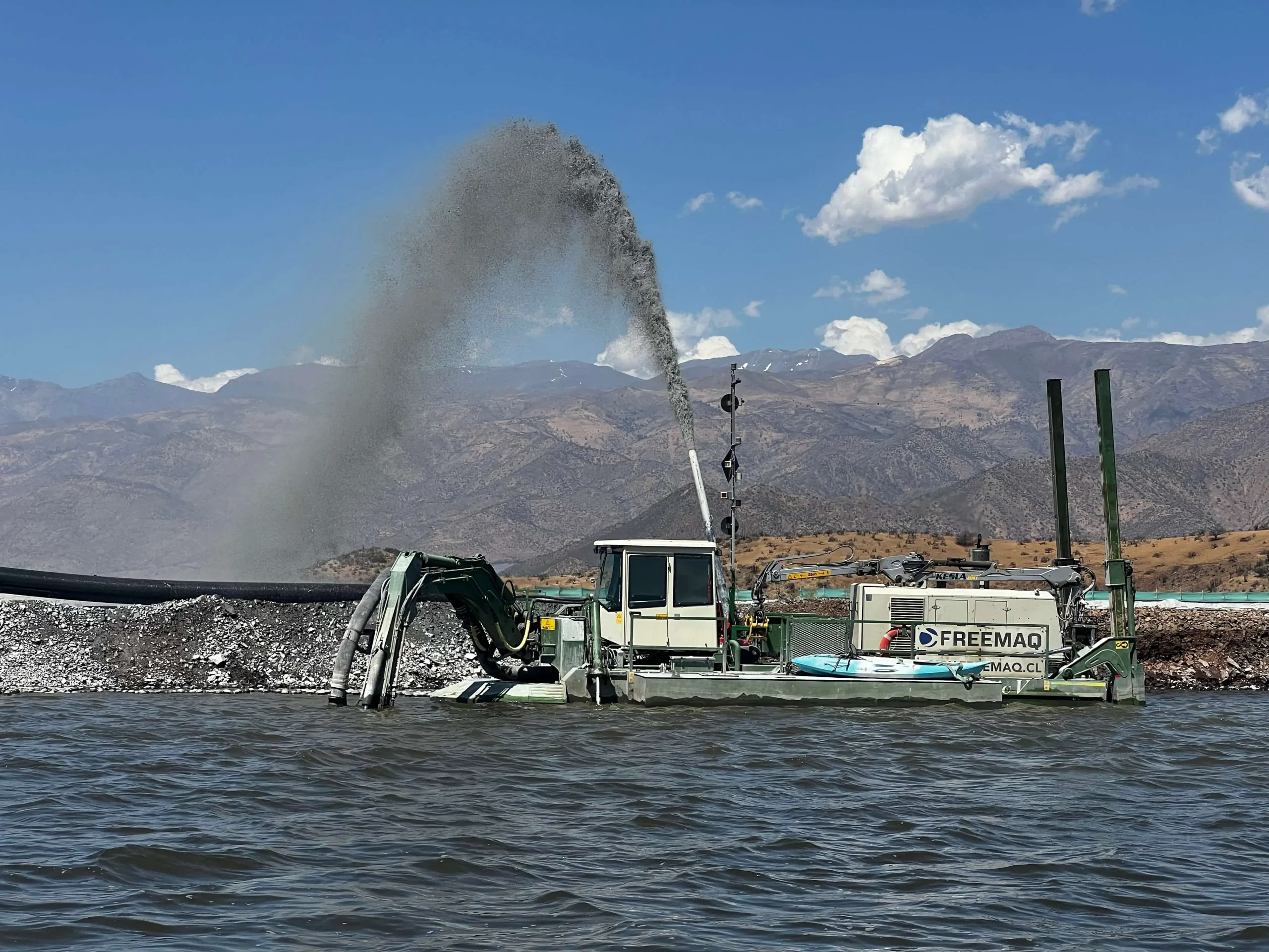 Draga anfibia operando en una laguna industrial para la recuperación de sólidos y valorización de materiales mediante tecnología de dragado sostenible.